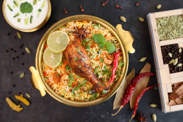 Chicken biryani Spicy Indian Malabar biryani Hyderabadi biryani, Dum Biriyani pulao golden bowl Kerala India Sri Lanka Pakistan basmati rice mixed rice dish with meat curry Ramadan Kareem, Eid